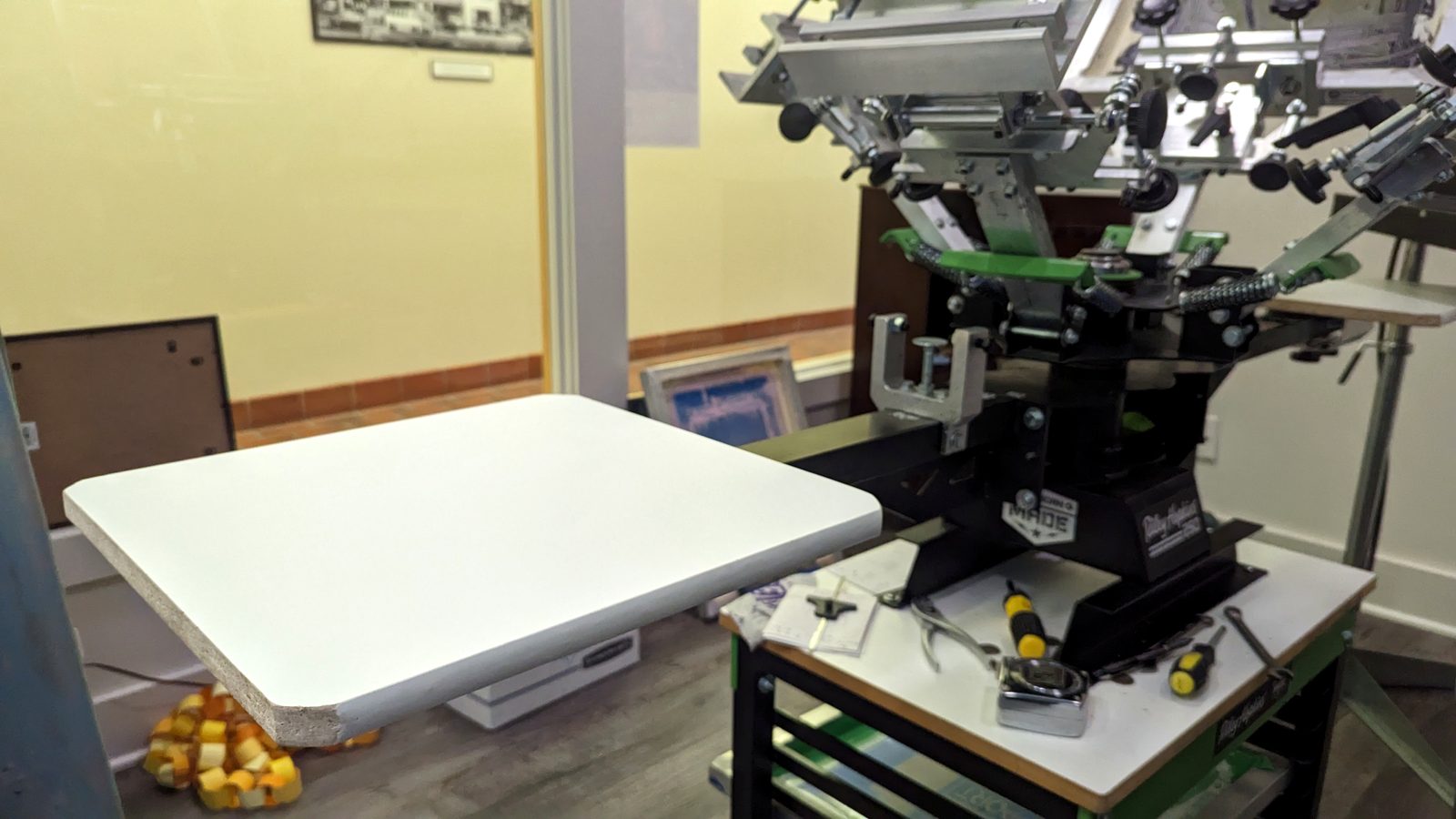 Manual screen printing press set up in the Retro Press shop